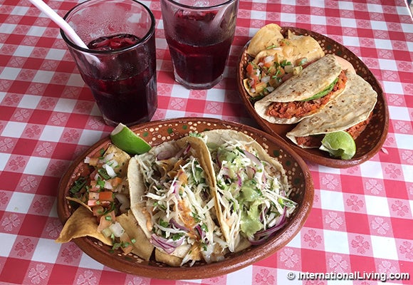 This meal, one plate of smoked marlin tacos and one plate of sea bass tacos, with two aguas de jamaica, cost us a total of ju