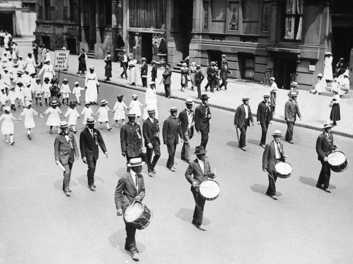 Women and children wore white while the men wore dark-colored suits.