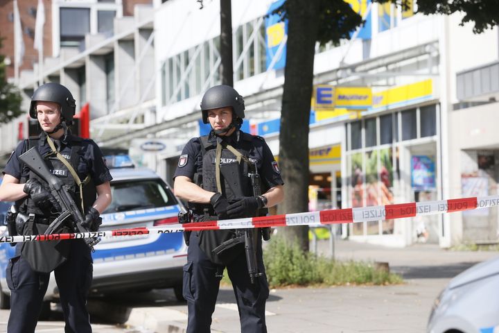 Police cordon off the area around a supermarket in the northern German city of Hamburg, where a man killed one person and wounded several others in a knife attack on July 28.