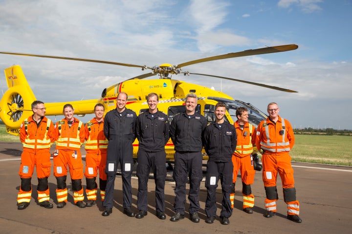 Prince William poses for a final photo with both day and night shift crews during his final shift with the East Anglian Air Ambulance (EAAA) at Cambridge Airport, Britain on July 27. 