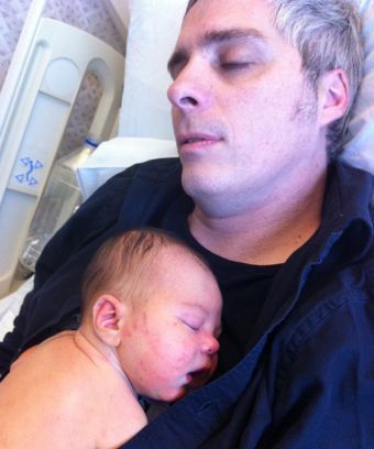 <p><em>Justin holds his newborn son in January 2011. He'd had his first brain surgery one month before.</em></p>