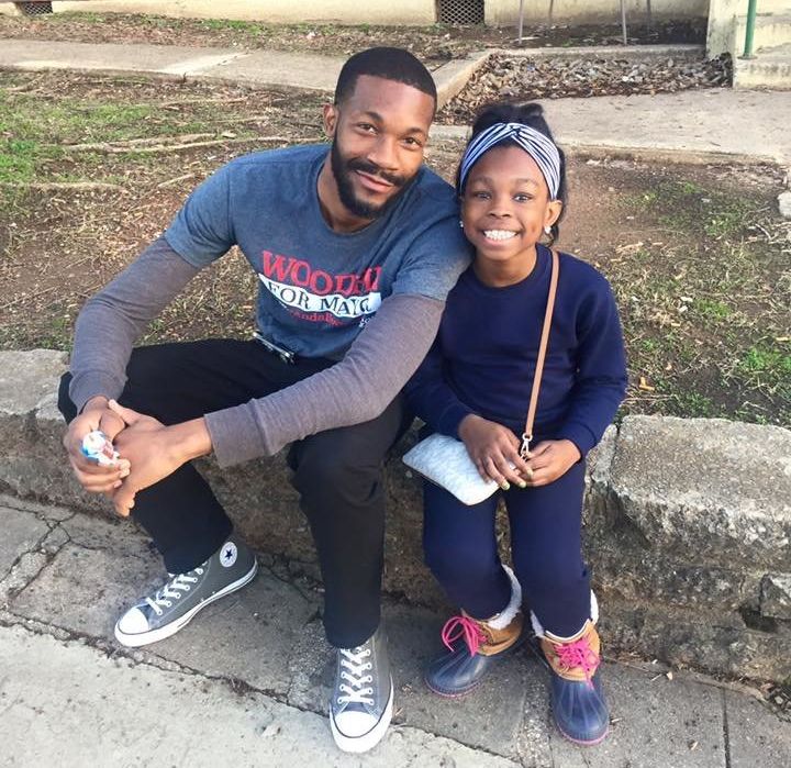 Woodfin shares a moment with a young girl while campaigning in Birmingham's Southtown neighborhood.