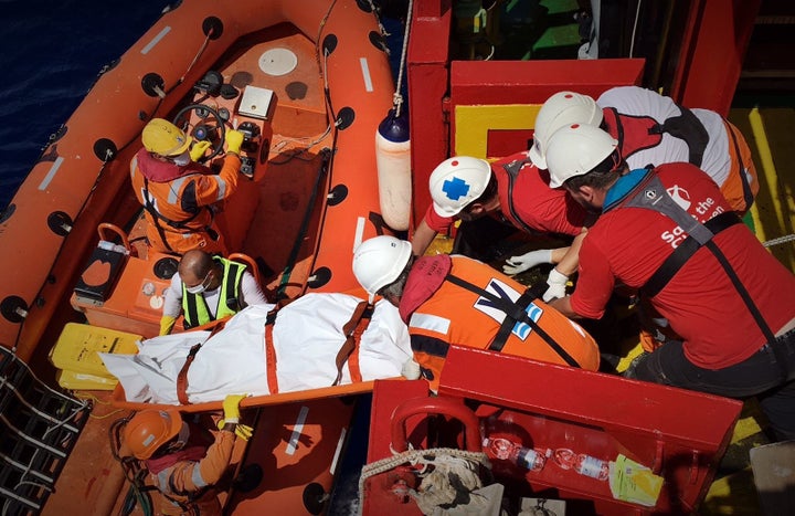 A body of a migrant recovered from an over-crowded rubber dinghy is lifted aboard the Save the Children ship.