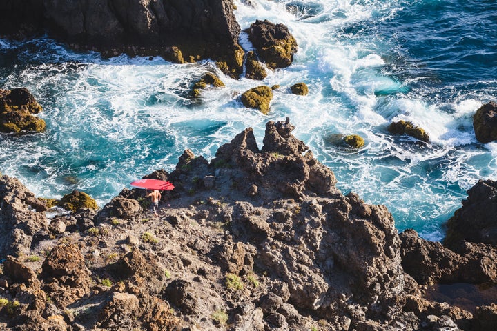 A surfer heads to the water