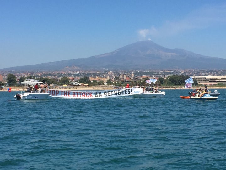 A 'STOP THE ATTACK ON REFUGEES' banner unfurled by part of the flotilla.