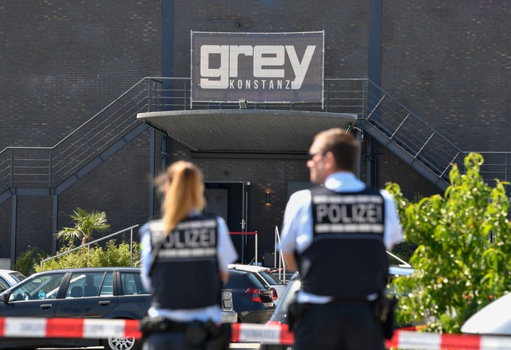 Policemen stand in front of the Grey Club in Konstanz, southern Germany, where a gunman opened fire, killing one and wounding four people before being shot by police early Sunday.