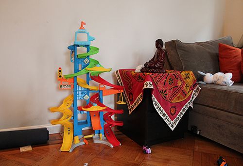 <p><strong>In the living room: Buddha, yoga mat and child’s toys.</strong></p>