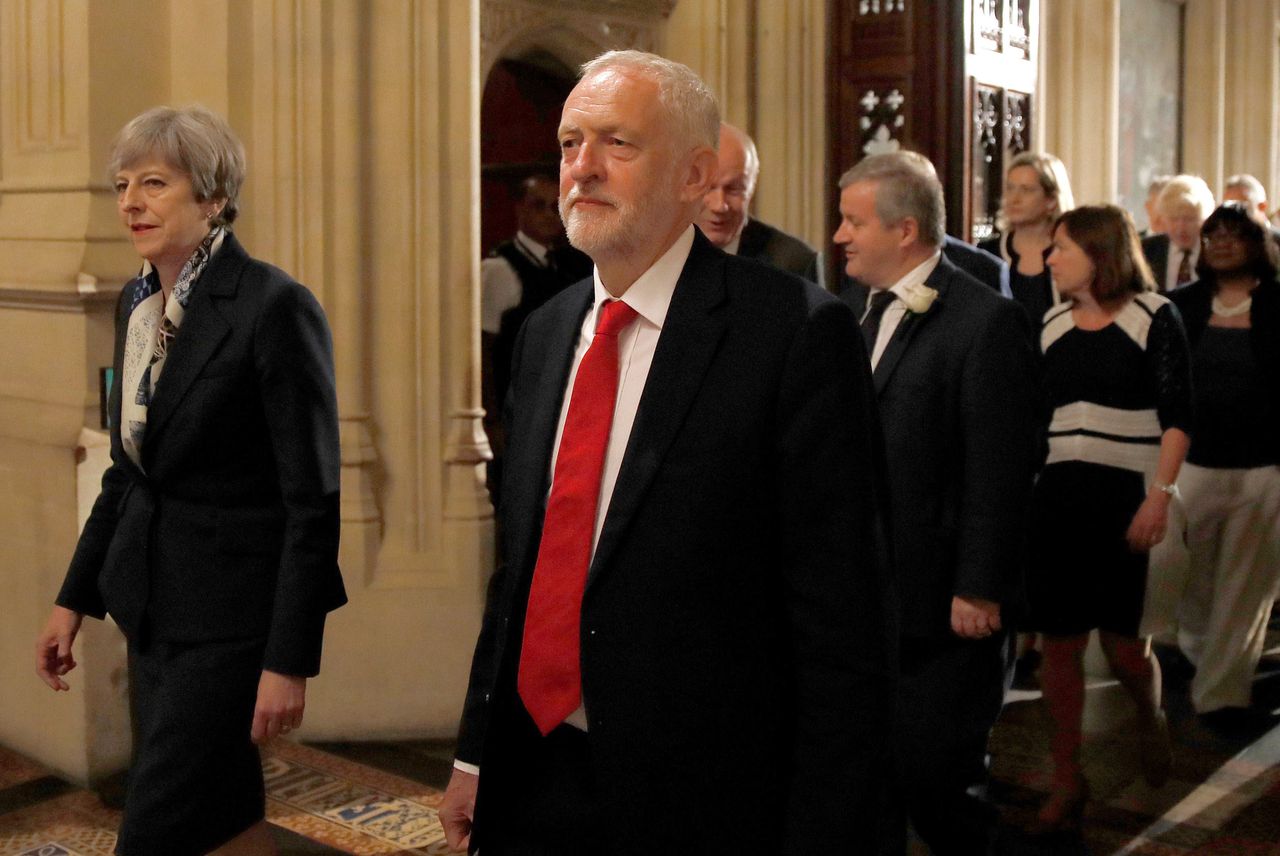 Theresa May and Jeremy Corbyn walk through the Peers Lobby during the State Opening of Parliament by Queen Elizabeth II, in the House of Lords.