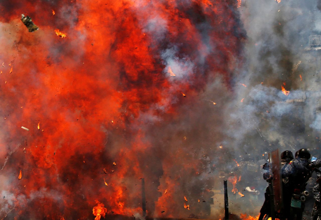 Flames erupt as clashes break out while the Constituent Assembly election is being carried out in Caracas on Sunday.