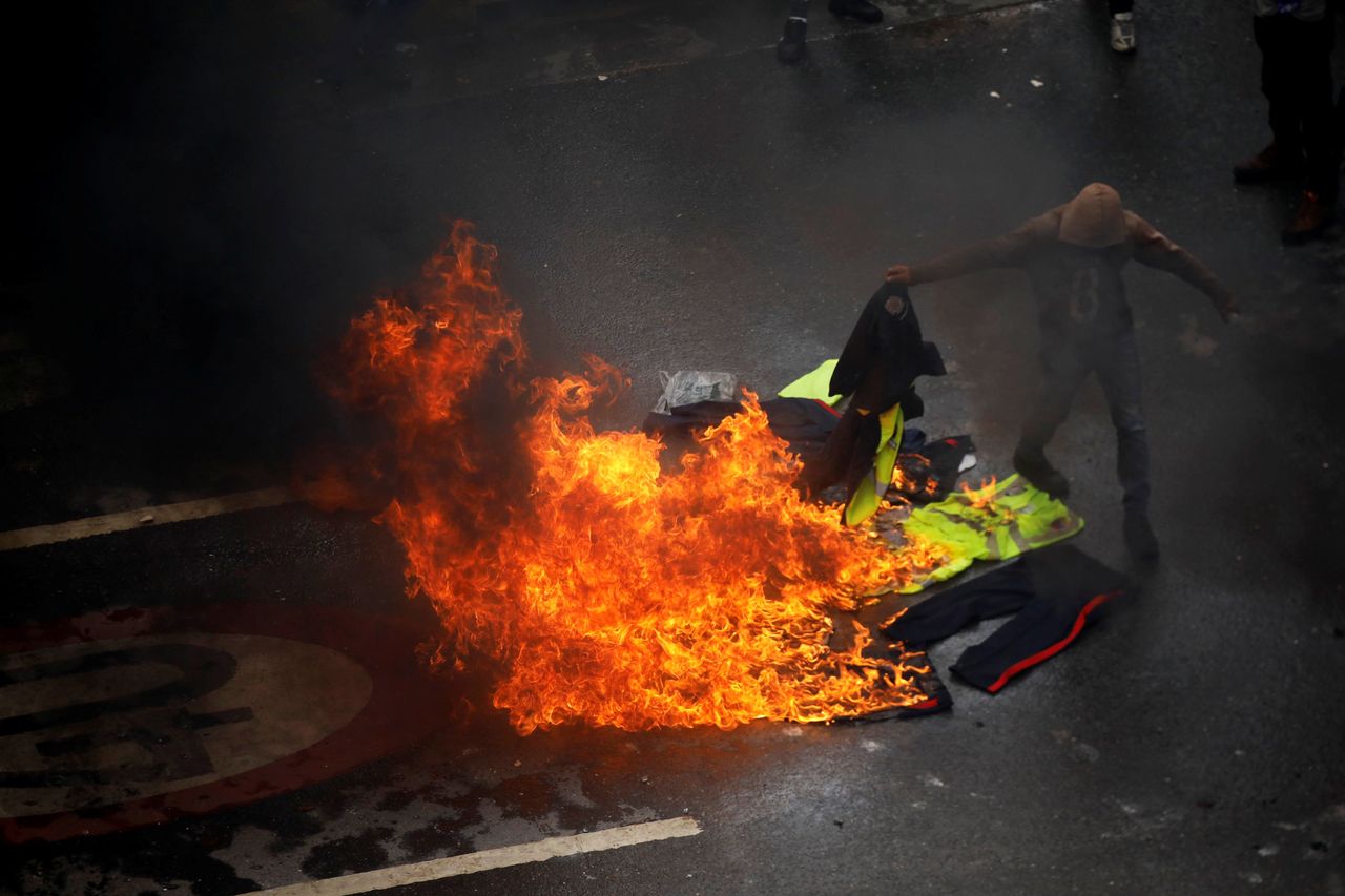 Demonstrators burn police uniforms amid clashes with authorities.