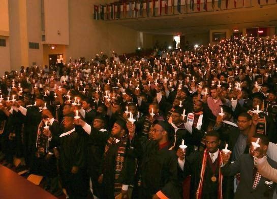 Morehouse graduates raise candles in King Chapel on the college’s campus.