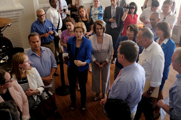 Democratic lawmakers huddle together in a coffee shop before unveiling their party's "A Better Deal" for working America