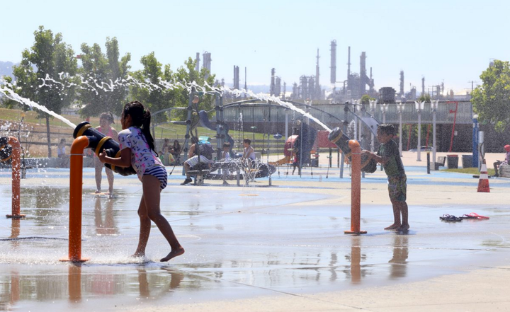 At new Waterfront Park, children play between the Valero and Phillips 66 refineries, right beside the Los Angeles Port.