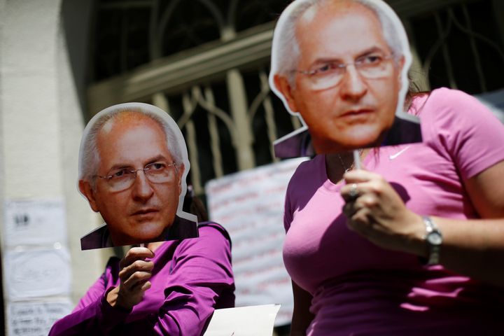 Opposition supporters hold masks of former Caracas mayor and jailed politician Antonio Ledezma during a rally last week.