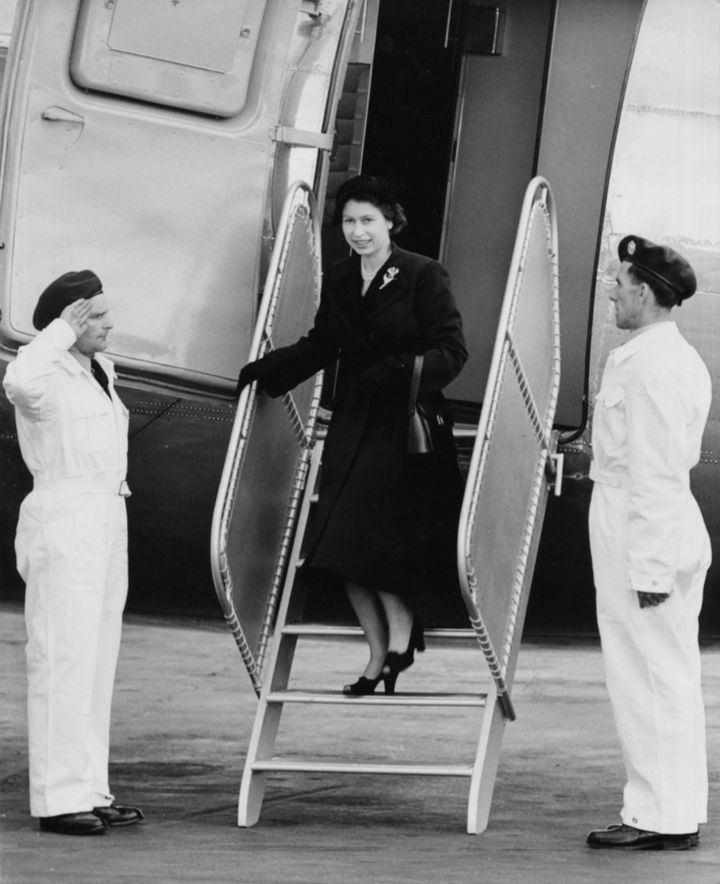 Queen Elizabeth II is saluted by the crew as she leaves her Viking airplane of the King's Flight, London Airport, June 3rd 1952.