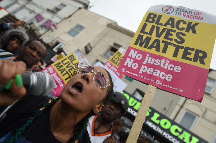 Hackey Stand Up To Racism protest outside a shop in Kingsland Road, east London, after young black man Rashan Charles died after a police chase