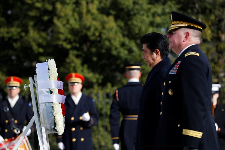 Japanese Prime Minister Shinzo Abe, accompanied by Maj. Gen. Mark Inch, lays a wreath at the Tomb of the Unknown Solider at Arlington National Cemetery in Arlington, Virginia, on Feb. 10. 