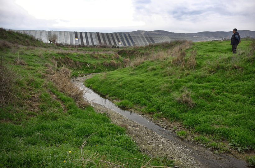 <em>The Ilisu Dam, seen in the background, will flood this land when it is finished.</em>