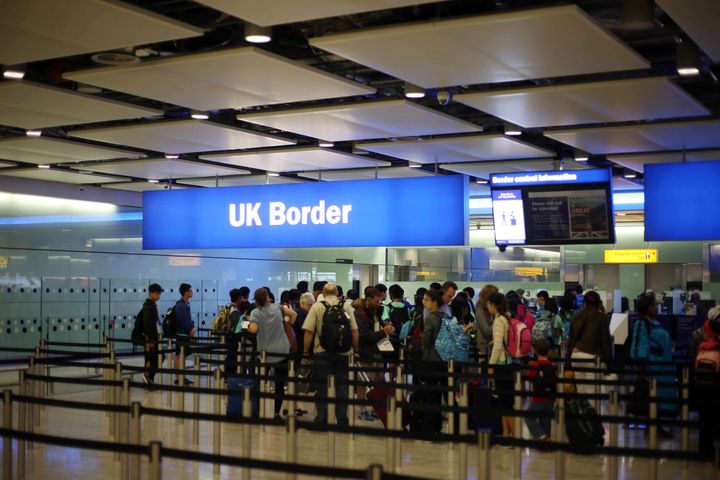 Passengers queue for the UK Border at Heathrow Airport