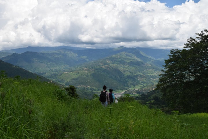 Community healthcare nurse and worker walking to a home visit in Achham. The actions of the US embassy in Nepal directly harm their work.