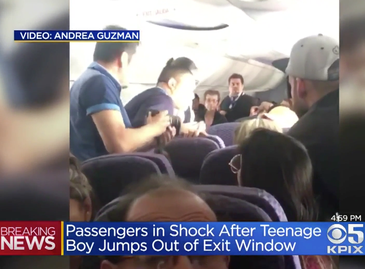 People are seen looking out of an open emergency exit door on a Copa Airlines flight into San Francisco on Tuesday.