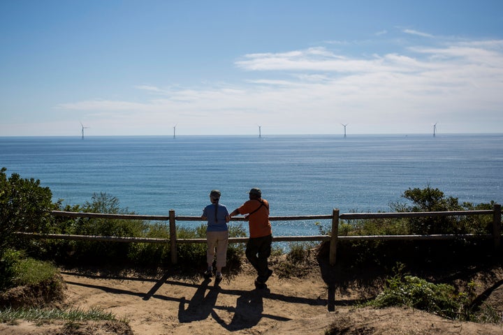 Tourists look out over the Block Island Wind Farm, located 3 miles off New Shoreham, Rhode Island.