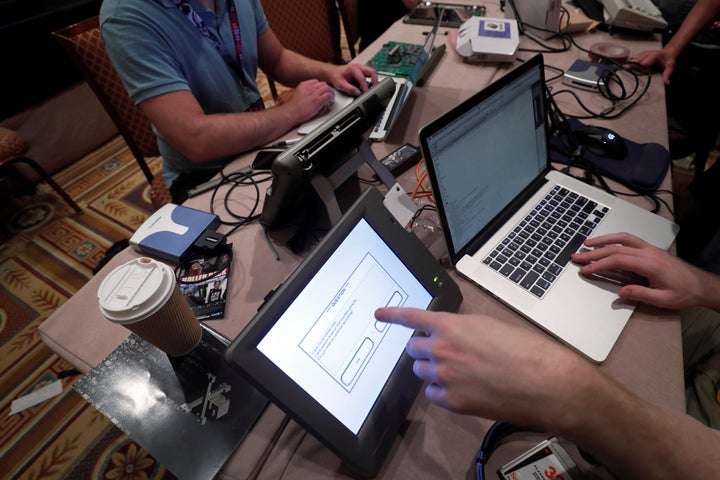 Hackers try to access and alter data from an electronic poll books in a Voting Machine Hacking Village during the Def Con hacker convention in Las Vegas, Nevada, U.S. on July 29, 2017.