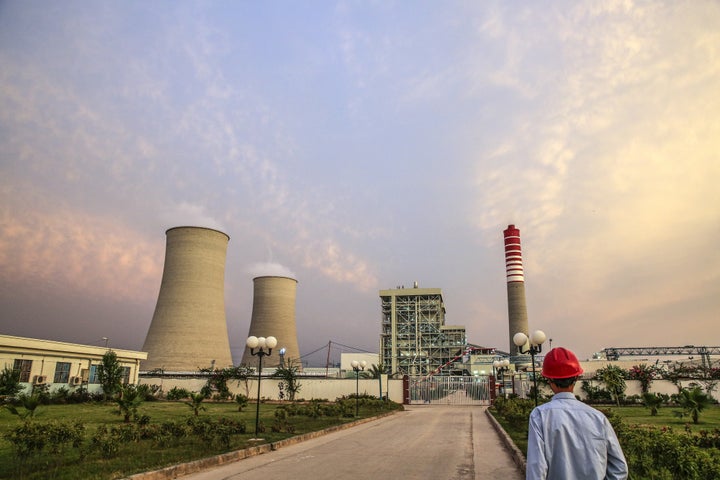 A Chinese worker walks along a path at the Sahiwal coal power plant, owned by China's state-owned Huaneng Shandong Rui Group, in Sahiwal, Punjab, Pakistan, on Wednesday, June 14, 2017. (Photographer: Asad Zaidi/Bloomberg via Getty Images)