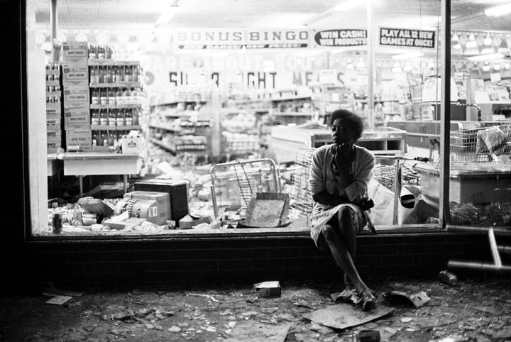 "Woman sits in store front window," courtesy of Jim Hubbard and the Charles H.