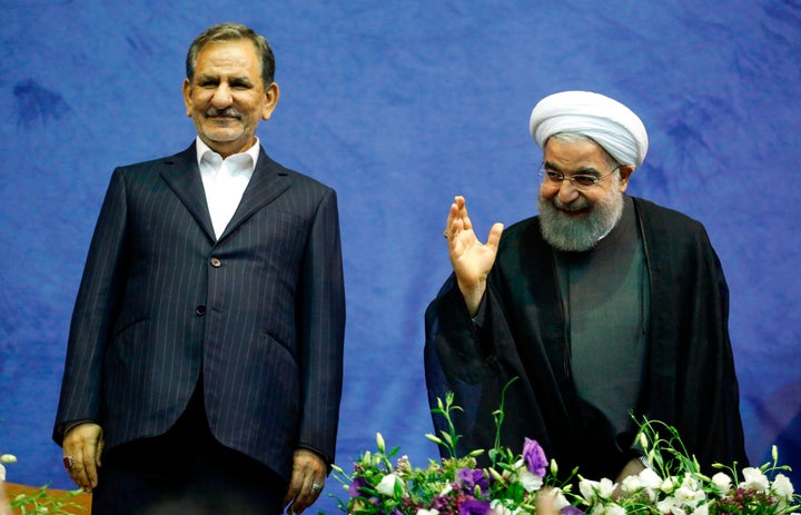 Iran's Supreme Leader Ayatollah Ali Khamenei, right, handed over the presidential mandate to Hassan Rouhani, left, during a ceremony broadcast on state TV Thursday.