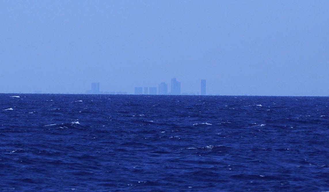 A picture taken from the Aquarius by HuffPost UK in which the buildings of Tripoli can be seen in the distance around 12 miles away.