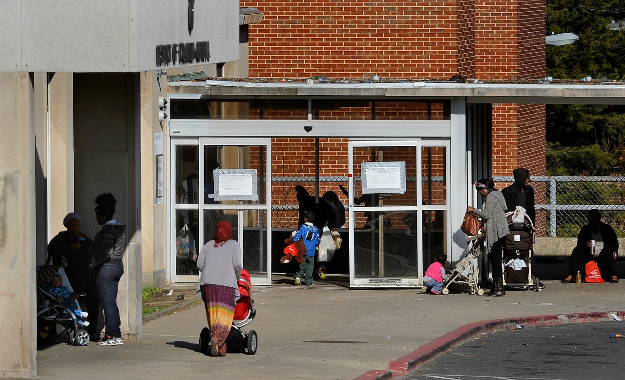 Residents of the homeless shelter on the site of the former D.C. General Hospital mingle in the late afternoon outside the facility.