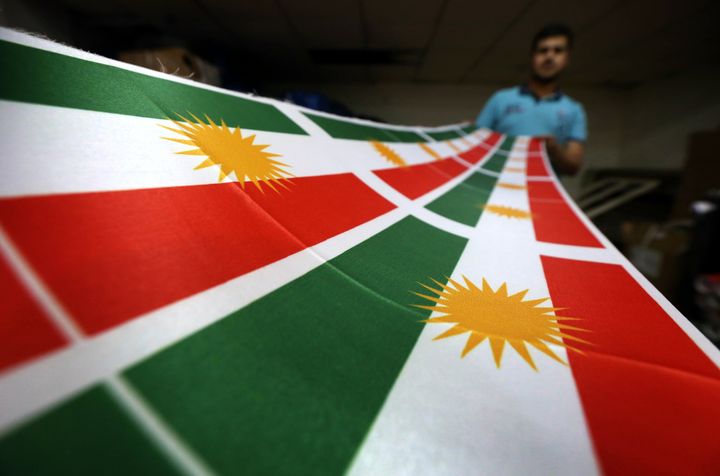 An Iraqi man prints a flag of Kurdistan. 