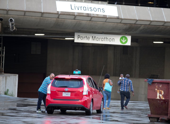 A family gets out of a taxi at Olympic Stadium, which is being used as temporary housing for asylum seekers, in Montreal, Quebec, Canada August 2, 2017. 