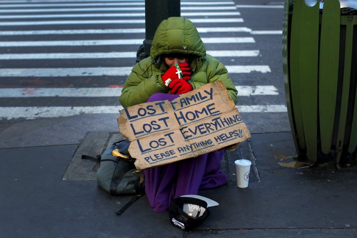 A homeless woman sits bundled against the cold in the Manhattan borough of New York City, January 4, 2016. 