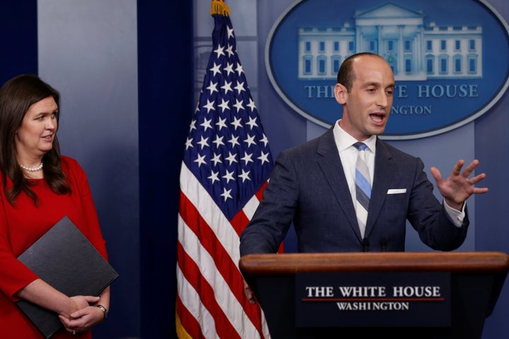 White House senior policy adviser Stephen Miller, right, addresses reporters on Aug. 2, 2017, as press secretary Sarah Huckabee Sanders looks on.