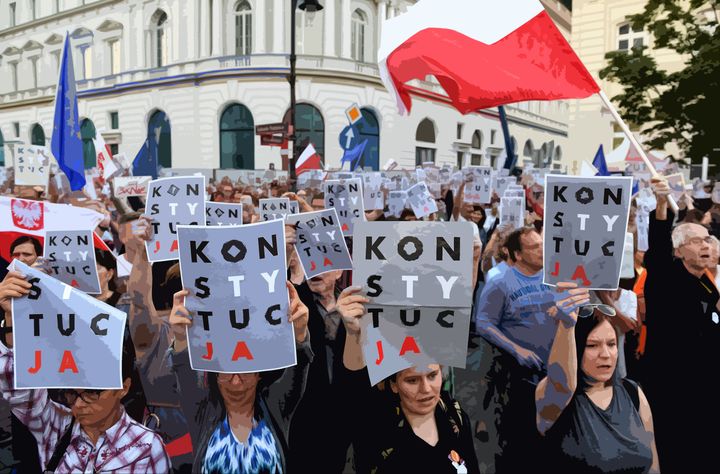 Demonstrators in Poland hold posters reading "constitution" to protest controversial judiciary reform.