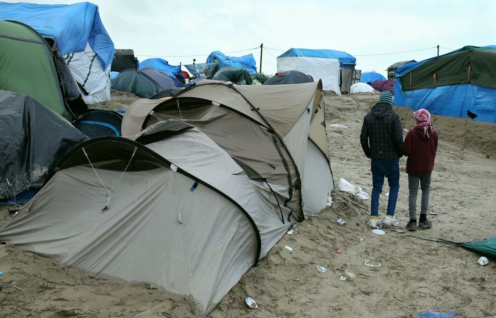 Orphaned children stand at the Jungle refugee camp in Calais, France in 2015