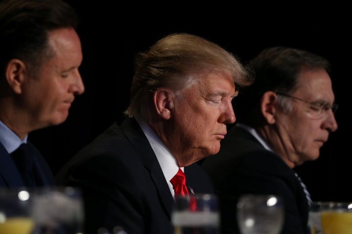 President Donald Trump prays during the National Prayer Breakfast event in Washington, U.S., February 2, 2017.