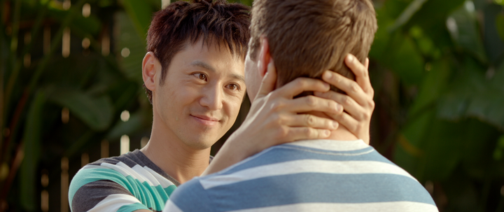 Danny (Barney Cheng) neck-hugs his lover.