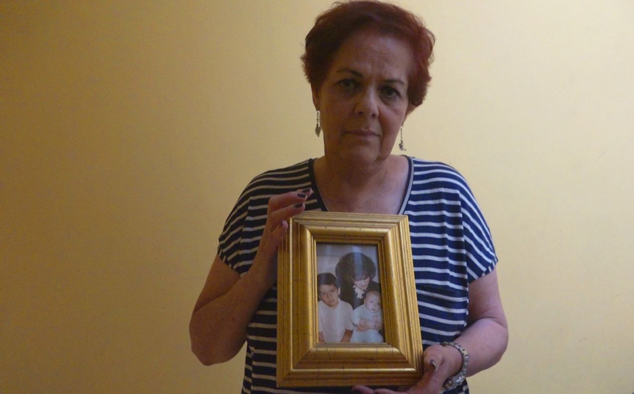 Blanca Aviña Guerrero holds a photo of her son, who she says was arbitrarily detained by the police in Mexico City.
