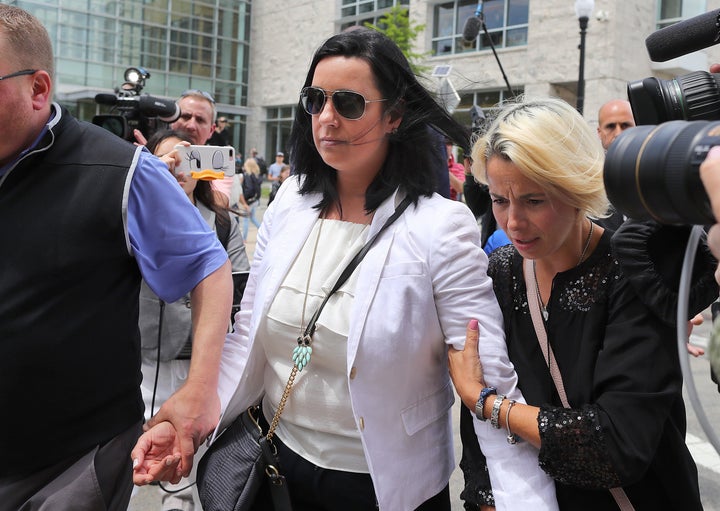 Conrad Roy's mother, Lynn Roy, is escorted from the courthouse in June after Michelle Carter was found guilty of involuntary manslaughter.