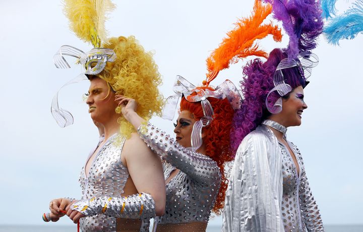 Pride participants adjust their costumes ahead of the parade