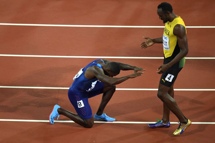 After winning the 100-meter dash, Justin Gatlin kneels in front of Jamaica's Usain Bolt after Gatlin won the final of the men's 100m athletics event at the 2017 IAAF World Championships.