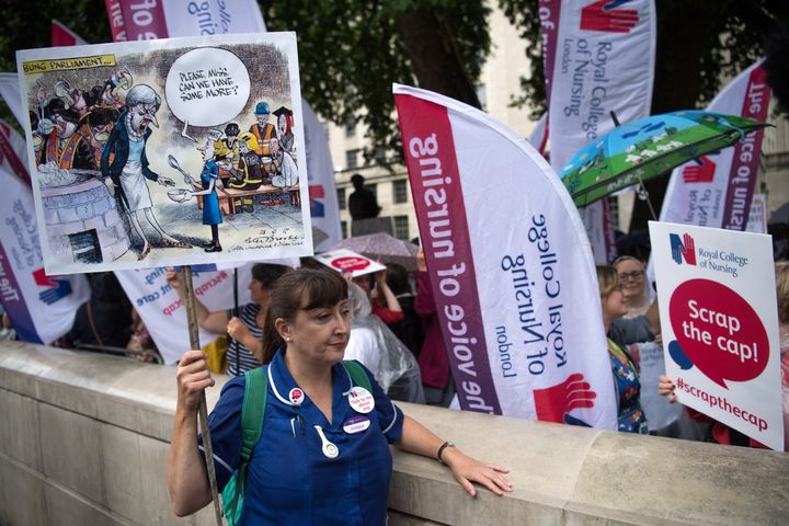 The NHS could 'go under' unless EU staff are given reassurances about their future after Brexit, the head of the Royal College of Nursing has warned; nurses are pictured above during a July pay protest in London
