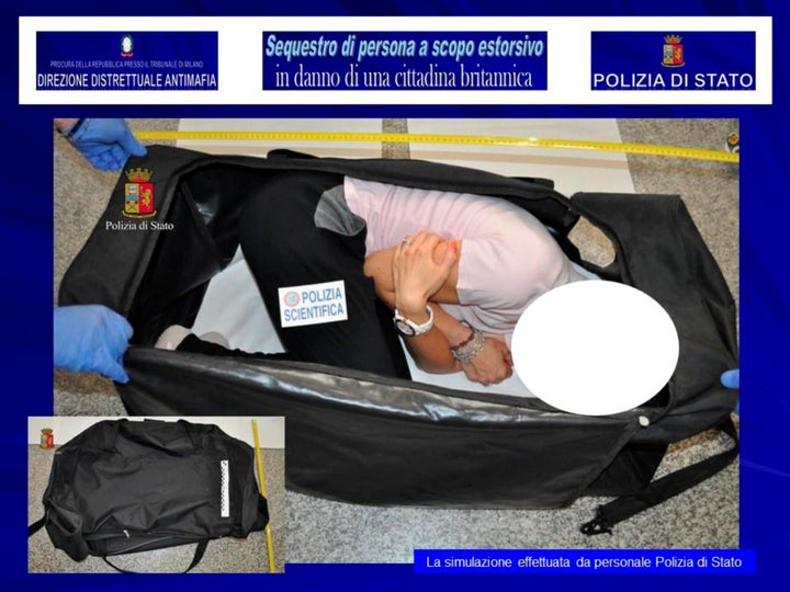 A person taking part in a reenactment by Italian police shows how Ayling was allegedly kept in a bag