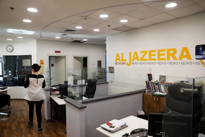 An employee walks inside an office of Qatar-based Al-Jazeera network in Jerusalem June 13, 2017.