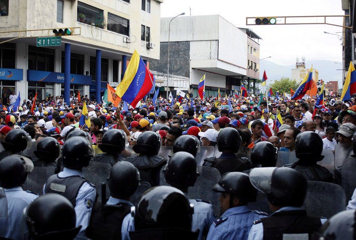 Opposition supporters clash with police during protests against unpopular leftist President Nicolas Maduro in San Cristobal, Venezuela, on April 19.