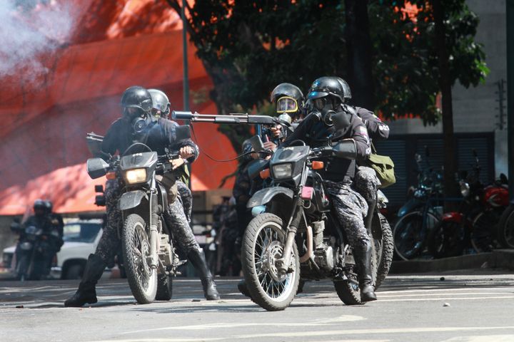 Riot police on their motorcycles charge on anti-government activists as they protest against the newly inaugurated Constituent Assembly.