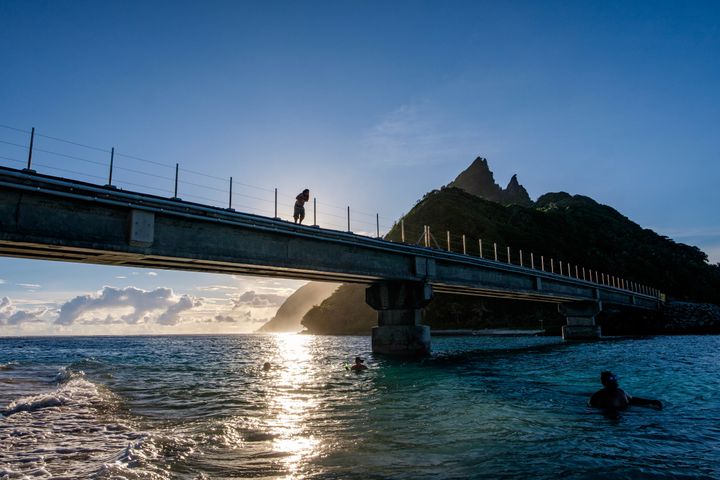 Bridge jumping into crystal clear South Pacific waters on the only bridge in American Samoa. It connects the islands of Olesega and Ofu — one of three islands with protected parkland. 